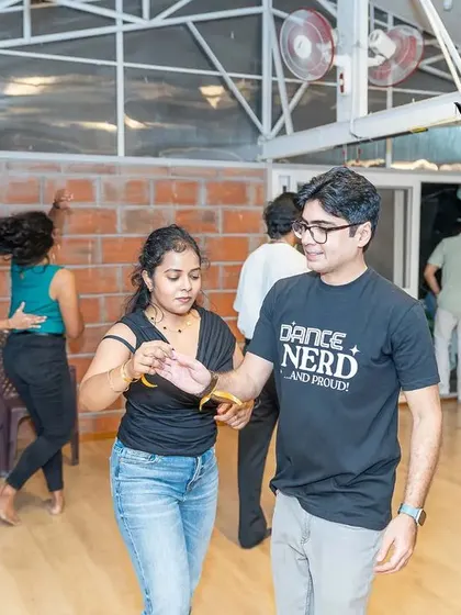 A student wearing our "Dance Nerd and Proud" t-shirt at the Motley Mixer. We are a community of people who are passionate about learning and growing.