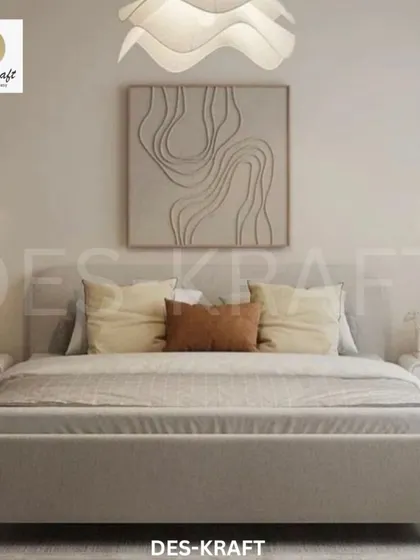 A frontal view of the bed, highlighting the symmetrical arrangement of the bedside tables and wall sconces, which contributes to the room's balanced and serene feel.