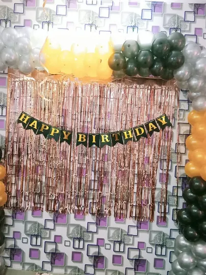 A closer look at a simple balloon arch with a shimmer curtain. This is a very popular and affordable option for home birthday parties.