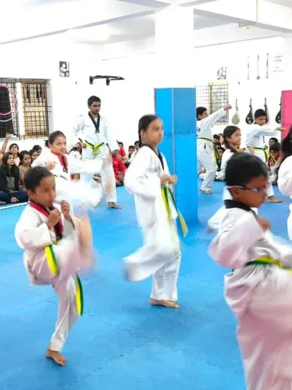 A class of green belts practicing their kicks.