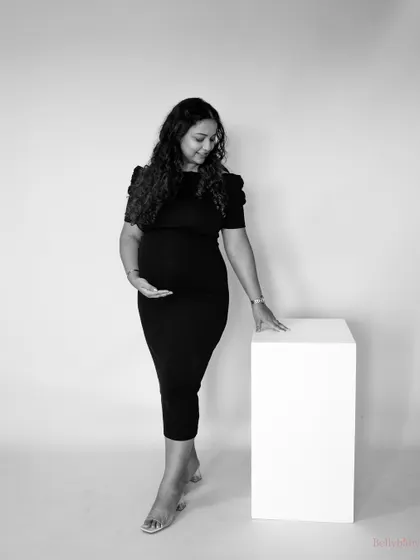 A simple, standing black and white portrait that feels both strong and gentle. It's a beautiful way to remember the feeling of carrying your baby.