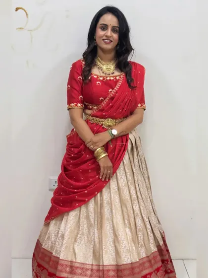 Celebrating courage and strength on Navaratri Day 6 with this vibrant red and cream custom half saree.