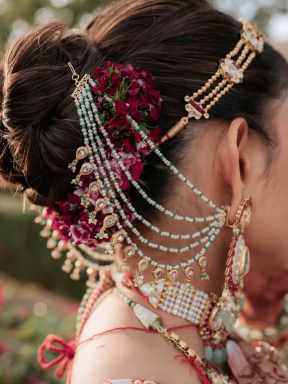 A look is never complete without the perfect hairstyle. My workshops include sessions from my expert team on professional hairstyling, where you learn to create beautiful, intricate updos like this one, adorned with fresh flowers and traditional accessories.