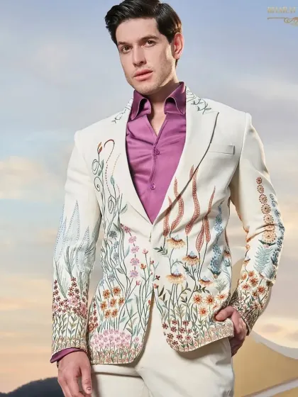 A fresh take on the formal tuxedo, this ivory jacket is adorned with vibrant, multi-colored floral embroidery. It's a perfect example of how I blend traditional craftsmanship with contemporary design for a standout cocktail or sangeet outfit.