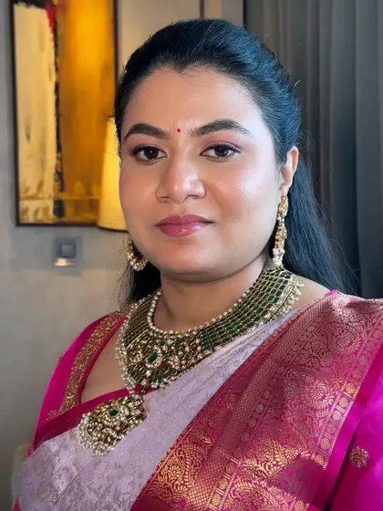 A portrait of a client showcasing a natural and radiant makeup look. The focus is on healthy, glowing skin and soft features, proving that you don't need heavy makeup to look stunning.