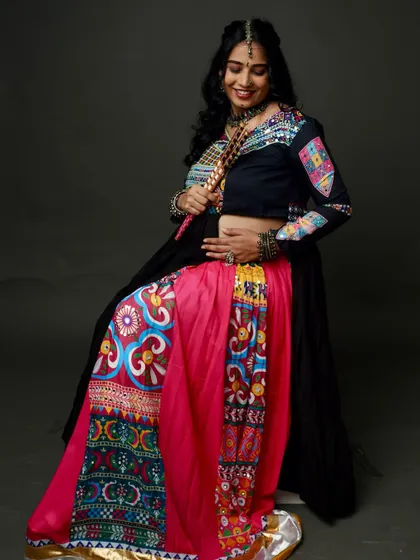 Celebrating with a fun Garba-themed maternity shoot! The colorful, traditional attire and her joyful expression are absolutely infectious.