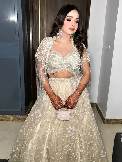 A full-length shot of this gorgeous engagement look. The fringed jacket adds a modern, trendy touch to the floral lehenga.