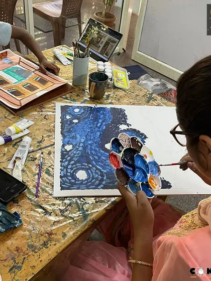 A student works on her version of Van Gogh's "The Starry Night," learning about impasto techniques and expressive color.