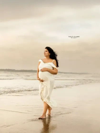 Sun, sea, and the sweetest wait. A solo walk along the shoreline, with the wind in her hair and hands on her bump. This image captures the feeling of peaceful anticipation.