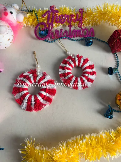 A pair of candy cane striped wreath ornaments. The red and white combination is so festive and cheerful.