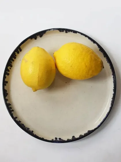 A simple yet elegant dessert plate with a dark, textured rim. The beauty of this piece lies in its understated design, allowing the food served on it to be the star.
