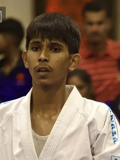 The determined gaze of a young fighter. This portrait captures the intensity and focus of one of our students during a tournament.