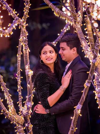 A sweet and tender close-up of the couple surrounded by fairy lights. The warm glow creates a soft and romantic mood, perfect for capturing their connection.
