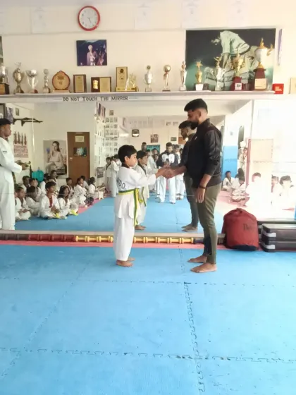 A handshake for a new yellow and green belt.