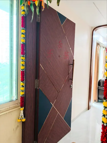 An angled view of the geometric-patterned main door, showing the subtle gold inlay that outlines the design.
