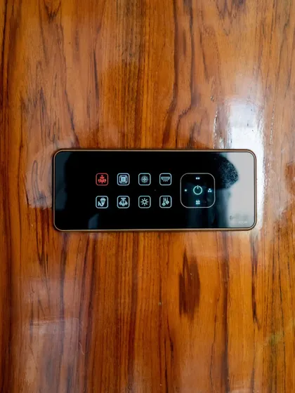 A close-up of a smart panel mounted on a polished wood surface, showcasing its versatility across different materials.