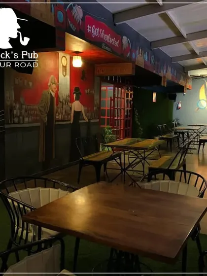 A wider view of my indoor seating area, with its unique murals and comfortable table setups. It's a great place to settle in for a meal.