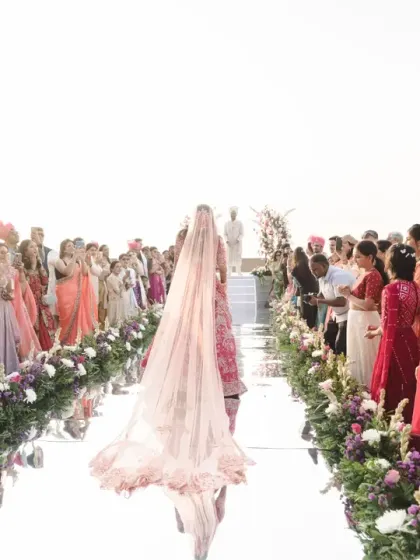 The bride's walk down the mirrored aisle, a stunning and emotional journey towards her groom. The reflection creates a beautiful, dreamlike effect.