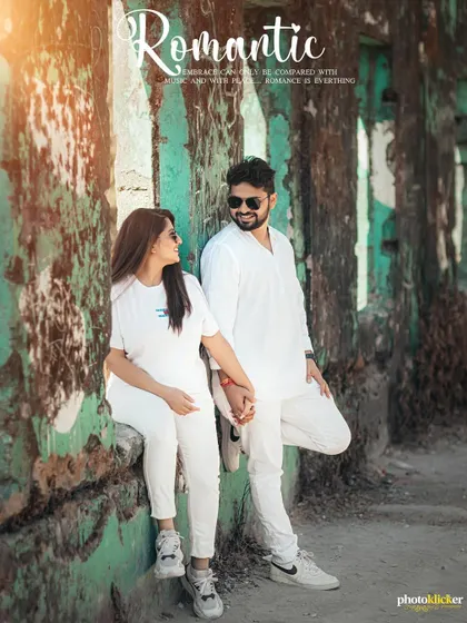 An album-style page featuring a couple in coordinated white outfits against a rustic green wall, capturing a romantic and stylish vibe.