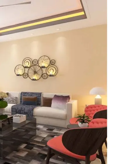 This living room design uses a warm, neutral color palette to create a cozy and inviting atmosphere. The unique wall-mounted light fixture acts as a piece of art, complementing the comfortable seating and elegant decor.