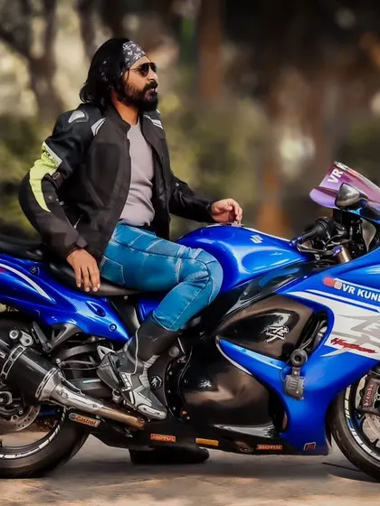 A three-quarter view of the Hayabusa, giving a great look at the bike's powerful engine and custom exhaust. The blurred background makes the blue superbike pop.