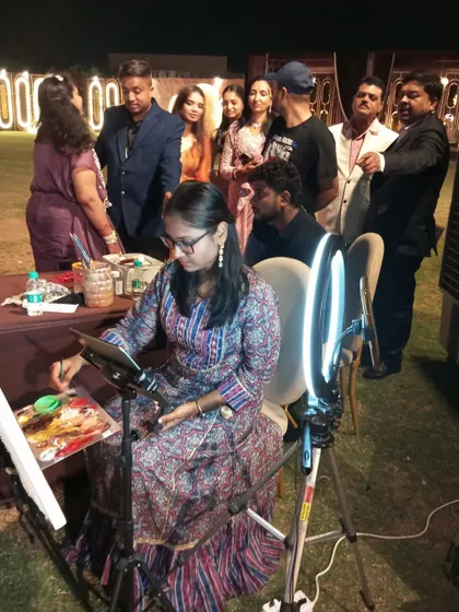 A crowd of guests has gathered to watch the live painting unfold in Raipur. It's always wonderful to share my artistic process and see their fascination with the artwork.