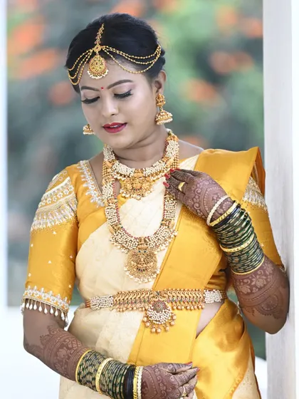 The radiant bride Pooja on her wedding day. I designed this classic yellow and off-white silk saree and blouse for her muhurtham.
