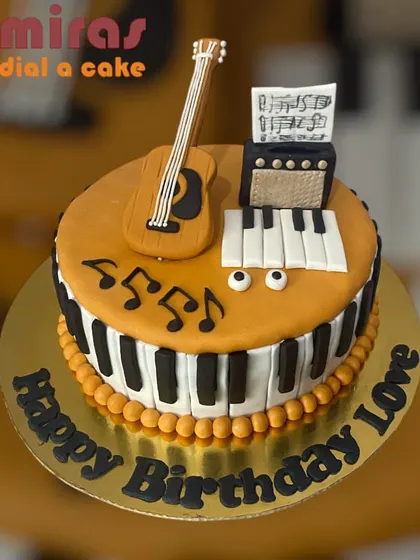 This cake hits all the right notes for a music lover. It's decorated with a piano key border and topped with a fondant guitar, amplifier, and sheet music.