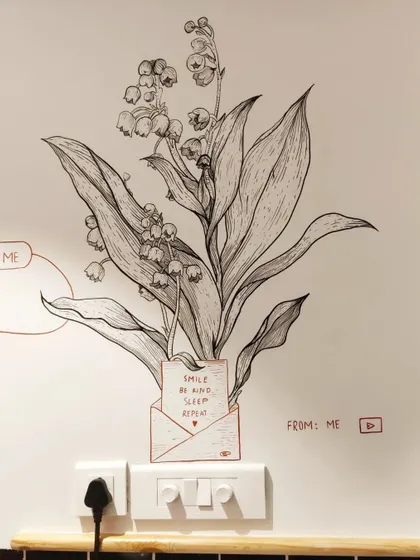 This detailed botanical illustration cleverly incorporates the power outlets into the design, turning a utility feature into a quirky part of the art.