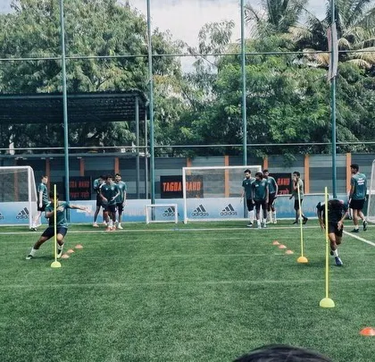 Players navigating a series of poles and cones during a technical drill. These exercises are designed to improve footwork and awareness.