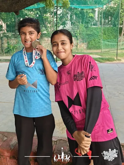 Developing multi-sport athletes. Anvi, from our program, proudly displays her medal after competing in the Ironkid Aquathlon, showcasing her swimming and running skills.