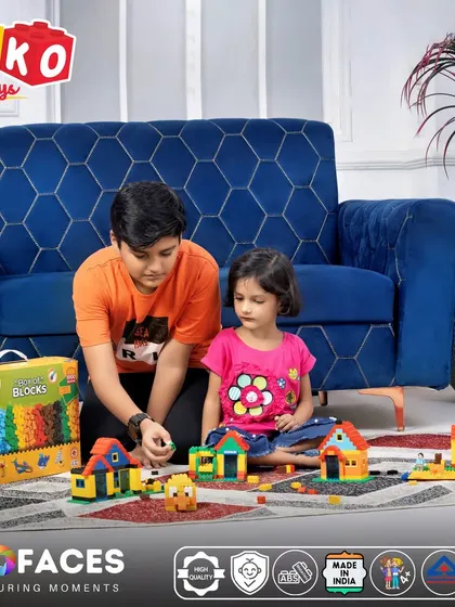 A lifestyle shot of two children playing with building block toys, creating a warm and authentic scene for a toy brand.