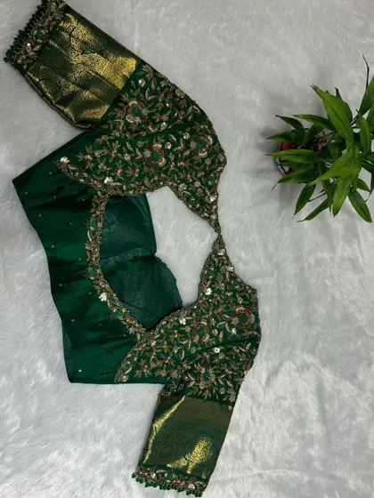 She wore tradition with a twist of glam. This bottle green blouse doesn't just shine, it drips luxury.