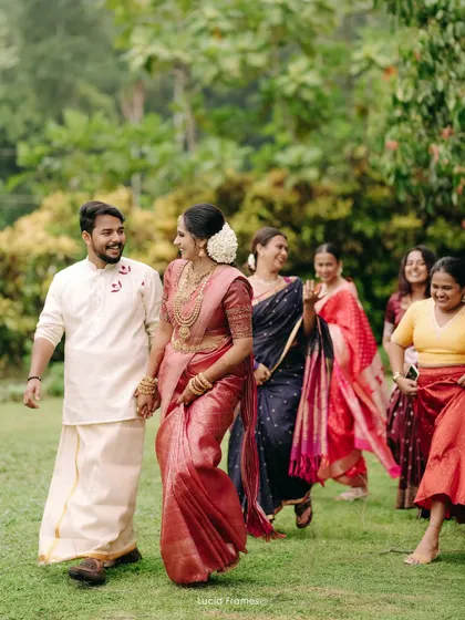 The happy couple walking with their bridesmaids, a candid moment full of smiles and laughter.