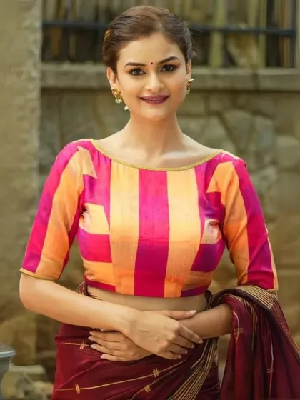 A pink and orange checkered blouse, a bold and beautiful choice.
