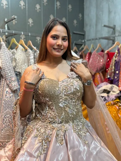 A happy client posing in the layered princess gown, ready for her event.