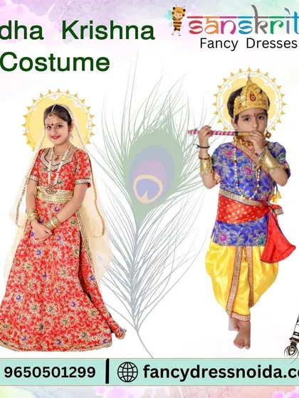 An elegant Radha Krishna costume set for children. The girl is dressed in a detailed red lehenga, while the boy wears a blue and yellow Krishna outfit, complete with a flute prop.