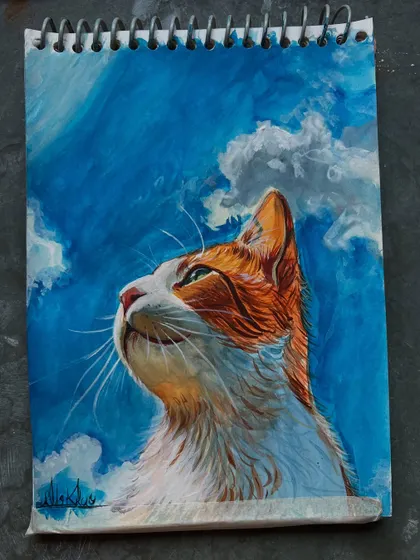 Another view of the finished cat painting, showing the vibrant blue sky and the cat's soft fur.