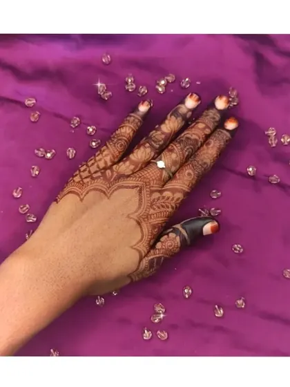 A slightly different angle of the same elegant back-of-hand design. The fine lines in the fingers and the shaded floral elements are clearly visible.