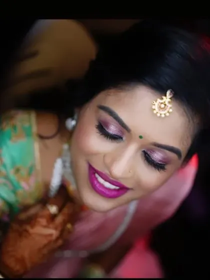 A close-up on the eyes and smile. The shimmery eyeshadow and bold lip are perfect for a glamorous reception.
