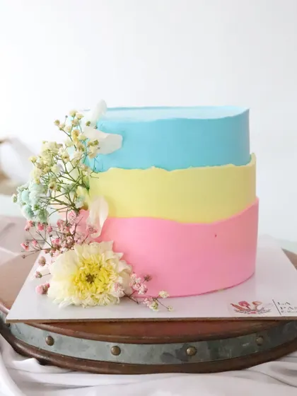A straight-on view of the three-toned pastel cake, perfect for a spring or summer celebration.