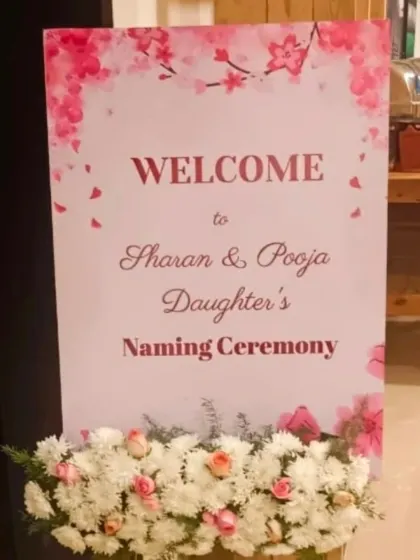 A welcome sign for a daughter's naming ceremony, designed with a delicate pink floral theme.