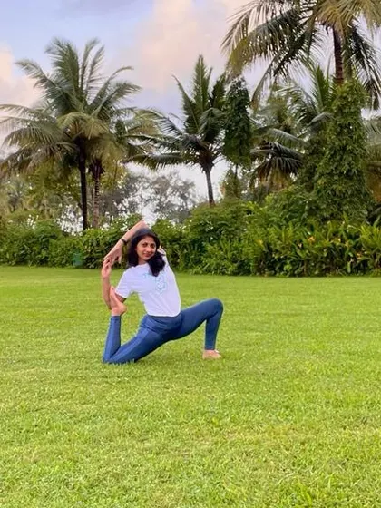 A beautiful one-legged pigeon pose on a lush green lawn. When you listen to yourself, everything comes naturally. That is yoga.