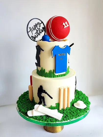 How's that for a cricket lover's cake! This two-tier creation is perfect for any cricket fan, complete with a jersey, ball, bat, and wickets, all handcrafted.