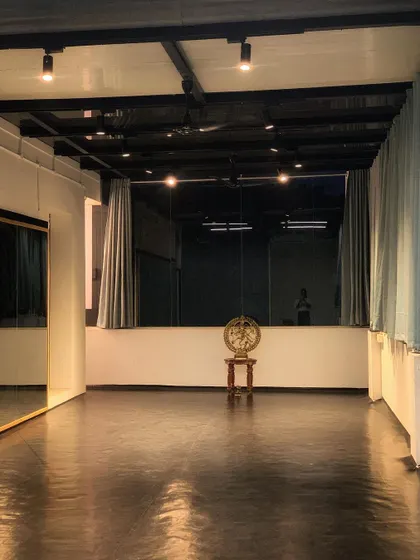 A serene evening view of the studio space, with the Nataraja idol standing as a silent guardian of our art.