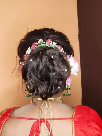 A messy, textured bun is a great choice for a sangeet or reception. I've adorned this one with flowers and pearl pins for a romantic, bohemian vibe.