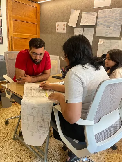 A candid shot of a team meeting, where we are reviewing drawings and discussing project details. This collaborative process is essential to our work.