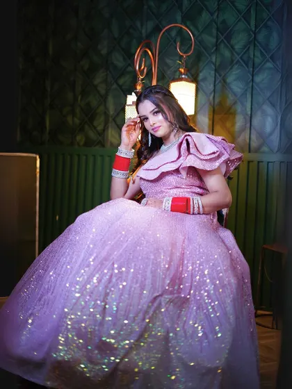 Another seated shot of the pink sequin gown, perfect for capturing a moment of quiet elegance.