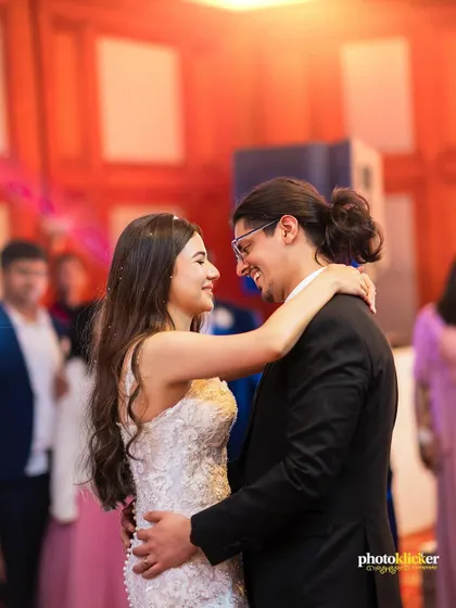 The first dance as husband and wife. A classic, romantic shot capturing the couple's happiness and connection.