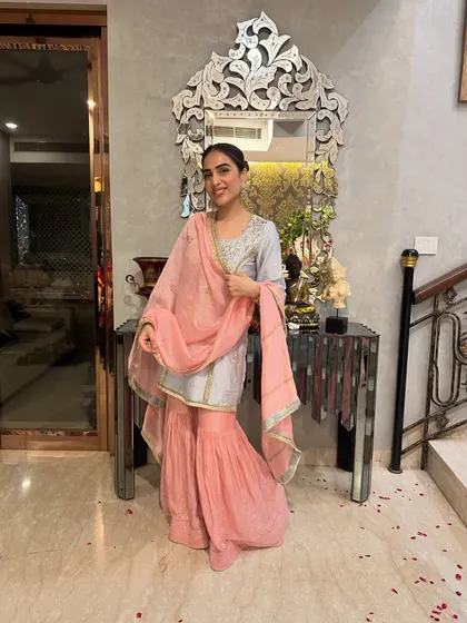 A candid, happy moment in my blue and pink sharara. This outfit is perfect for festive celebrations at home, like this Ganpati puja.